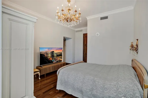 a bedroom with furniture and a chandelier