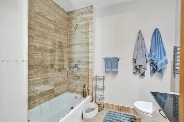 a bathroom with a shower and a toilet