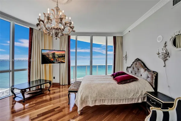 a bedroom with a bed and a chandelier