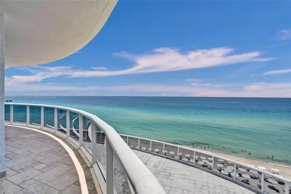 a view of a balcony with an ocean