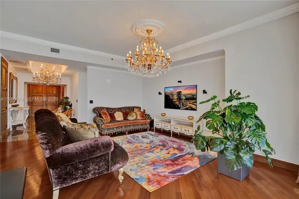 a living room with furniture and a chandelier