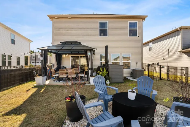 a view of a patio with table and chairs a barbeque