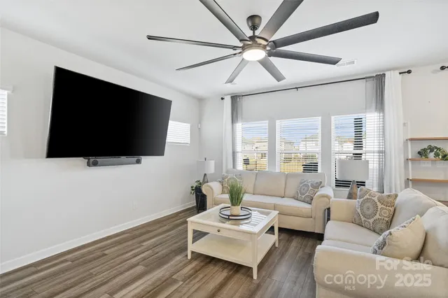 a living room with kitchen island furniture and a large window