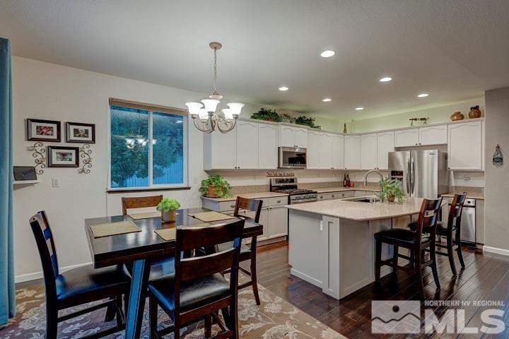 10520 Baton Court Reno, NV 89521 - Photo 14 of 38 a view of a dining room with furniture window and wooden floor