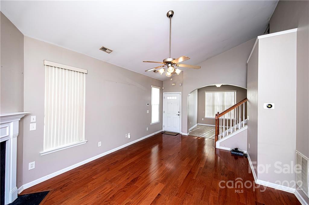 949 Copperstone Lane, Unit 203 Fort Mill, SC 29708 - Photo 3 of 19 a view of an empty room with wooden floor and a window