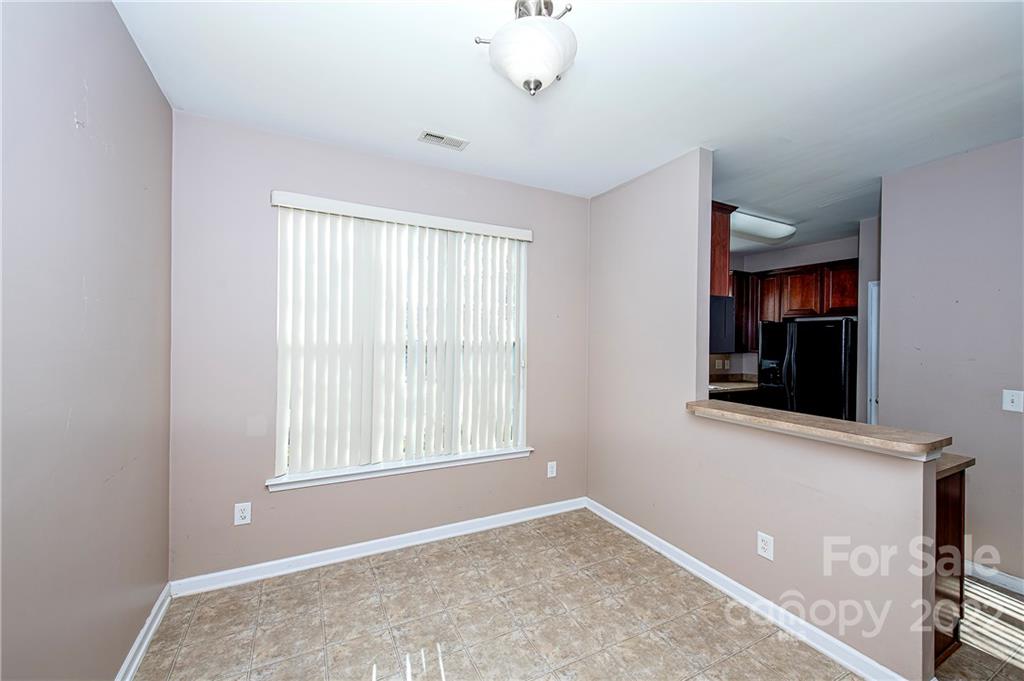 949 Copperstone Lane, Unit 203 Fort Mill, SC 29708 - Photo 4 of 19 a view of an empty room with window and hardwood floor