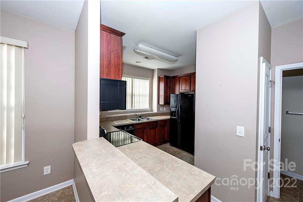 949 Copperstone Lane, Unit 203 Fort Mill, SC 29708 - Photo 5 of 19 a kitchen with a refrigerator and a stove top oven