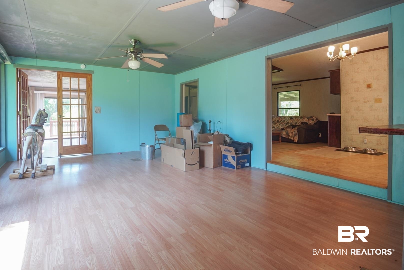9190 County Road 97 Elberta, AL 36530 - Photo 39 of 53 Misc room featuring wood-type flooring, ceiling fan with notable chandelier, and plenty of natural light