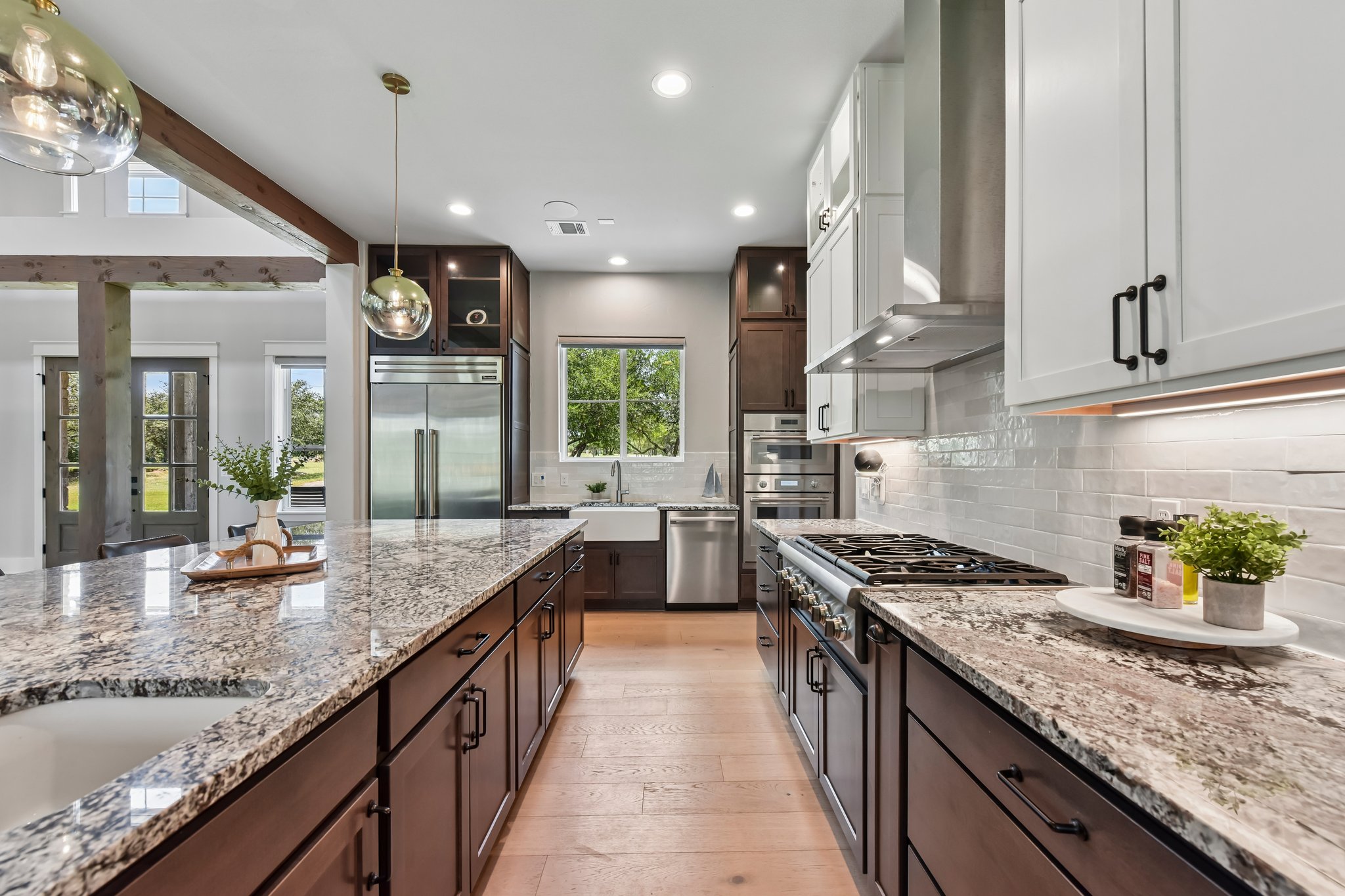 2203 Improver Road Spicewood, TX 78669 - Photo 14 of 38 Culinary delights await in this chef-inspired kitchen with a grand island and high-end appliances.