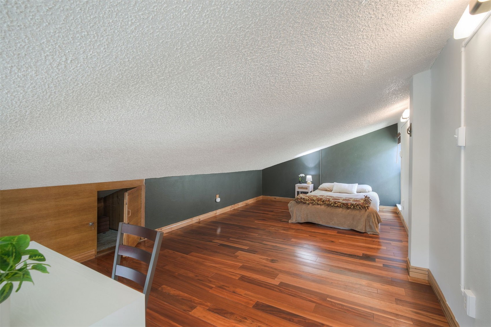 7031 Ryan Gulch Road, Unit 301 Silverthorne, CO 80498 - Photo 18 of 37 a bedroom with a bed and lamp on desk