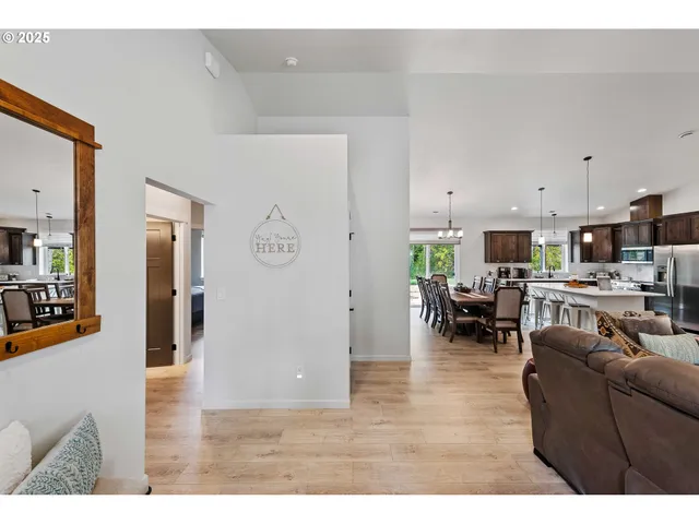 a living room with furniture and view of kitchen