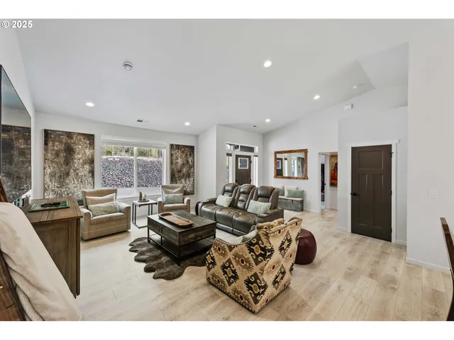 a living room with furniture large window and a table