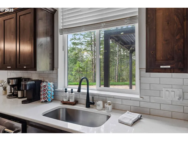 a kitchen with a sink and large window