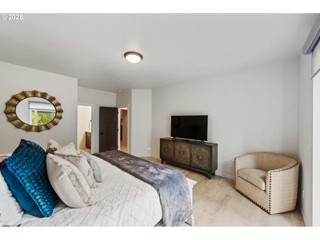 a bedroom with bed and a flat screen tv