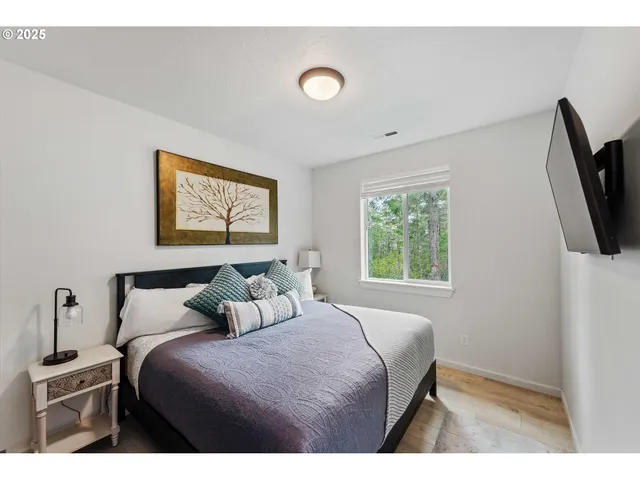 a bedroom with a bed and a flat screen tv