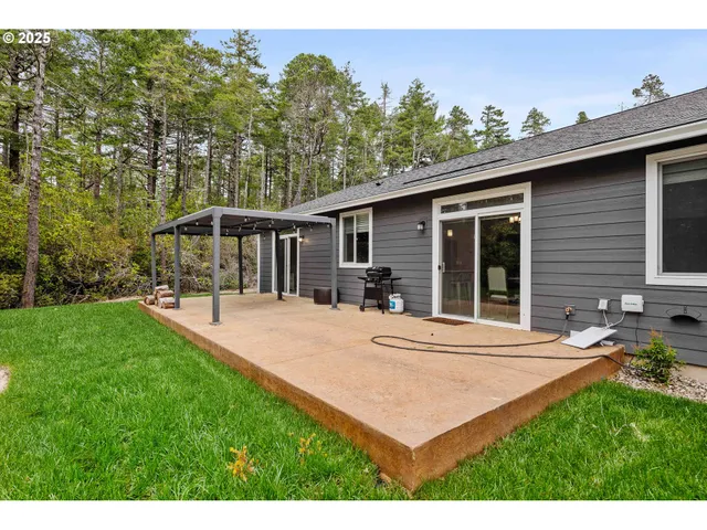 a view of a house with backyard and sitting area