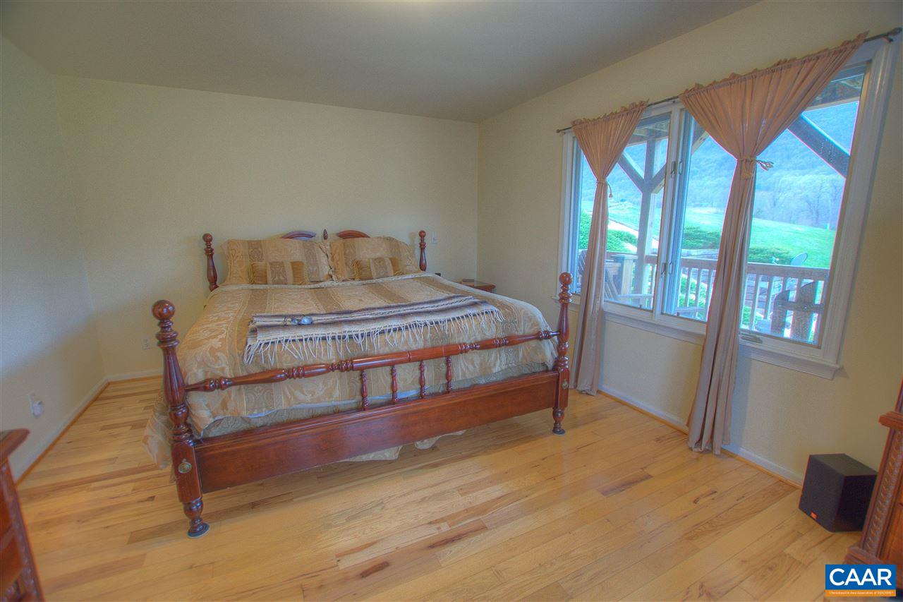 264 Twin Ridge Lane Afton, VA 22920 - Photo 18 of 49 a bedroom with a bed and large windows