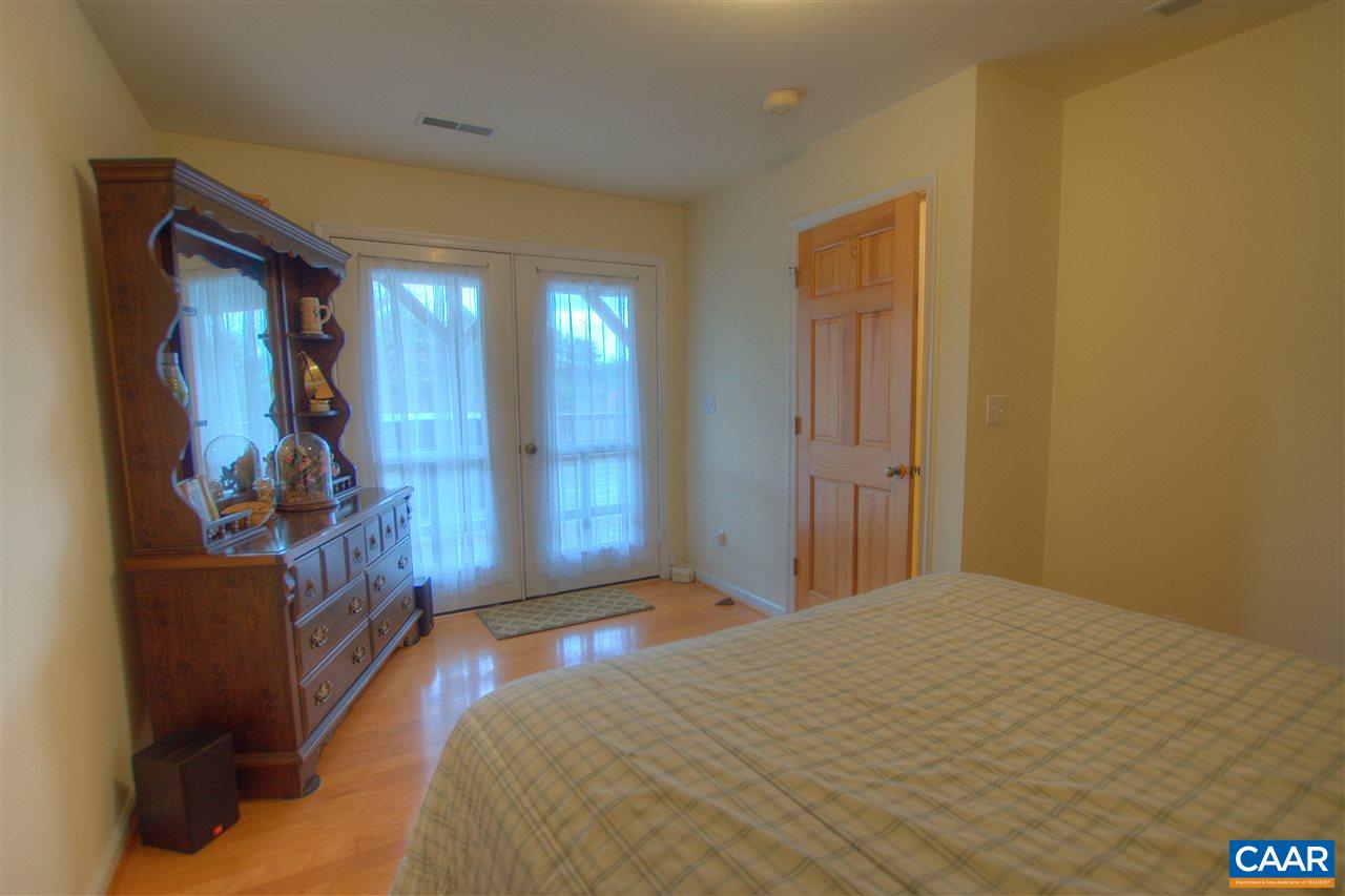 264 Twin Ridge Lane Afton, VA 22920 - Photo 26 of 49 a bedroom with a bed and a mirror