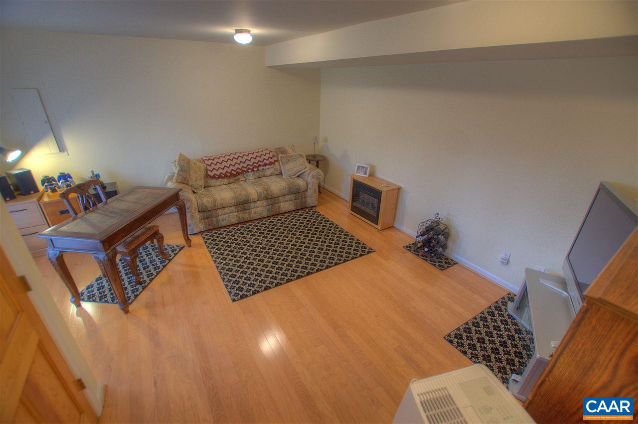 264 Twin Ridge Lane Afton, VA 22920 - Photo 30 of 49 a bedroom with a bed and wooden floor