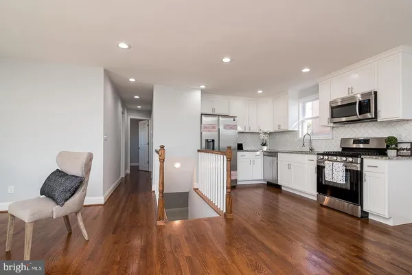a stove top oven sitting inside of a kitchen
