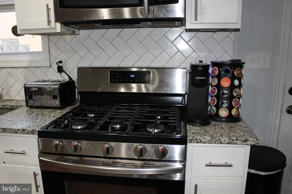 a kitchen with refrigerator and window