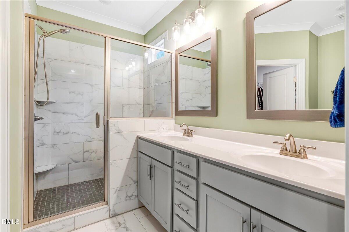 1208 Montgomery Road Franklinton, NC 27525 - Photo 17 of 61 a bathroom with a double vanity sink mirror and shower