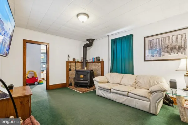 a bedroom with a bed and a dresser with wooden floor