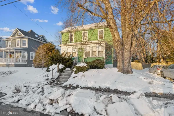 a view of a house with a snow in the yard