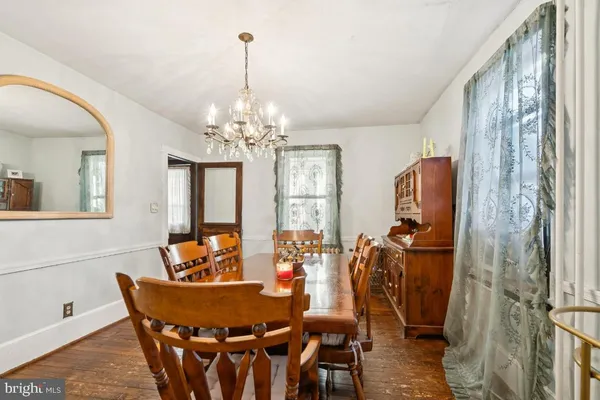 a kitchen with a dining table chairs and a refrigerator