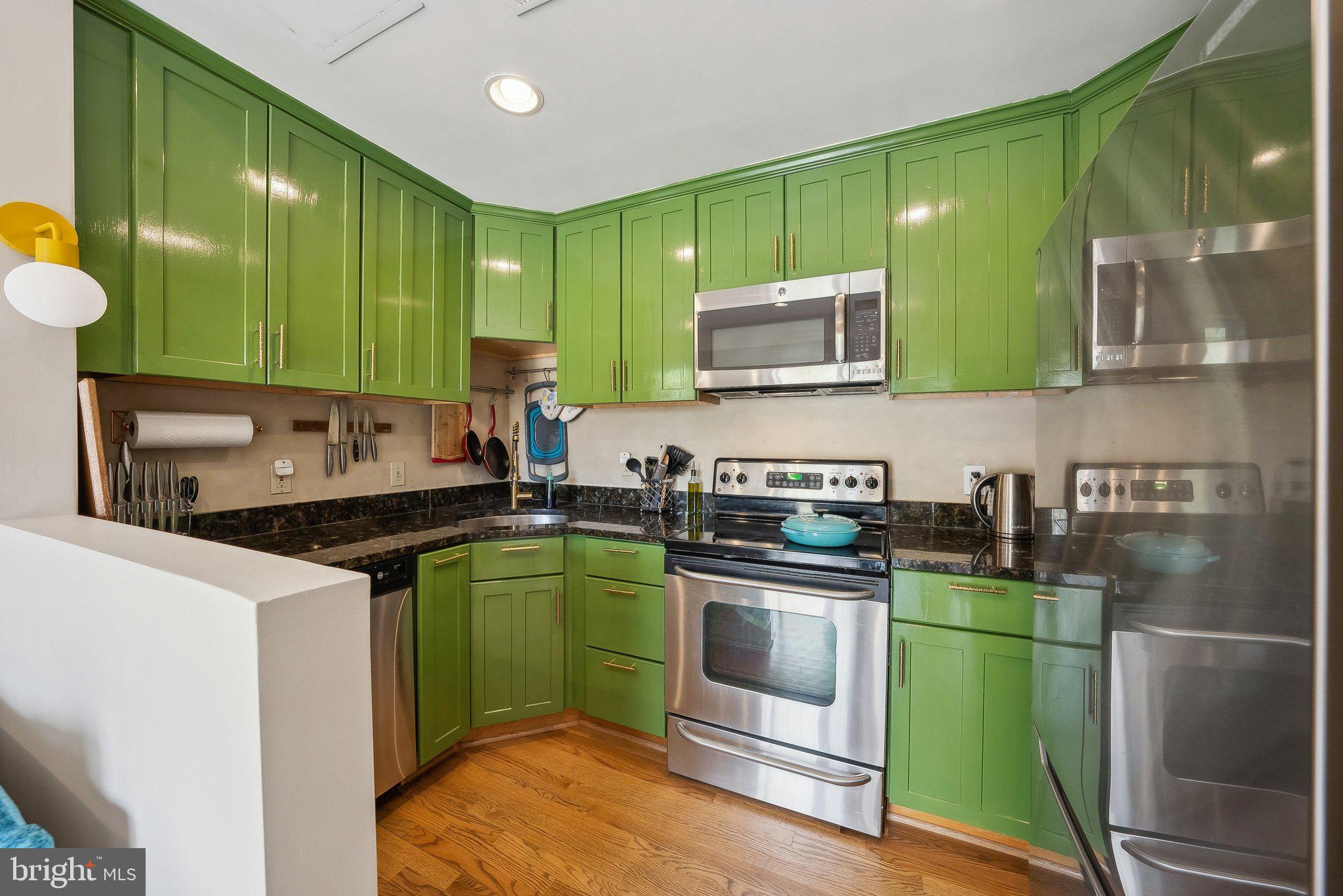 2630 Adams Mill Road Northwest, Unit 303 Washington, DC 20009 - Photo 11 of 18 a kitchen with sink a microwave and cabinets