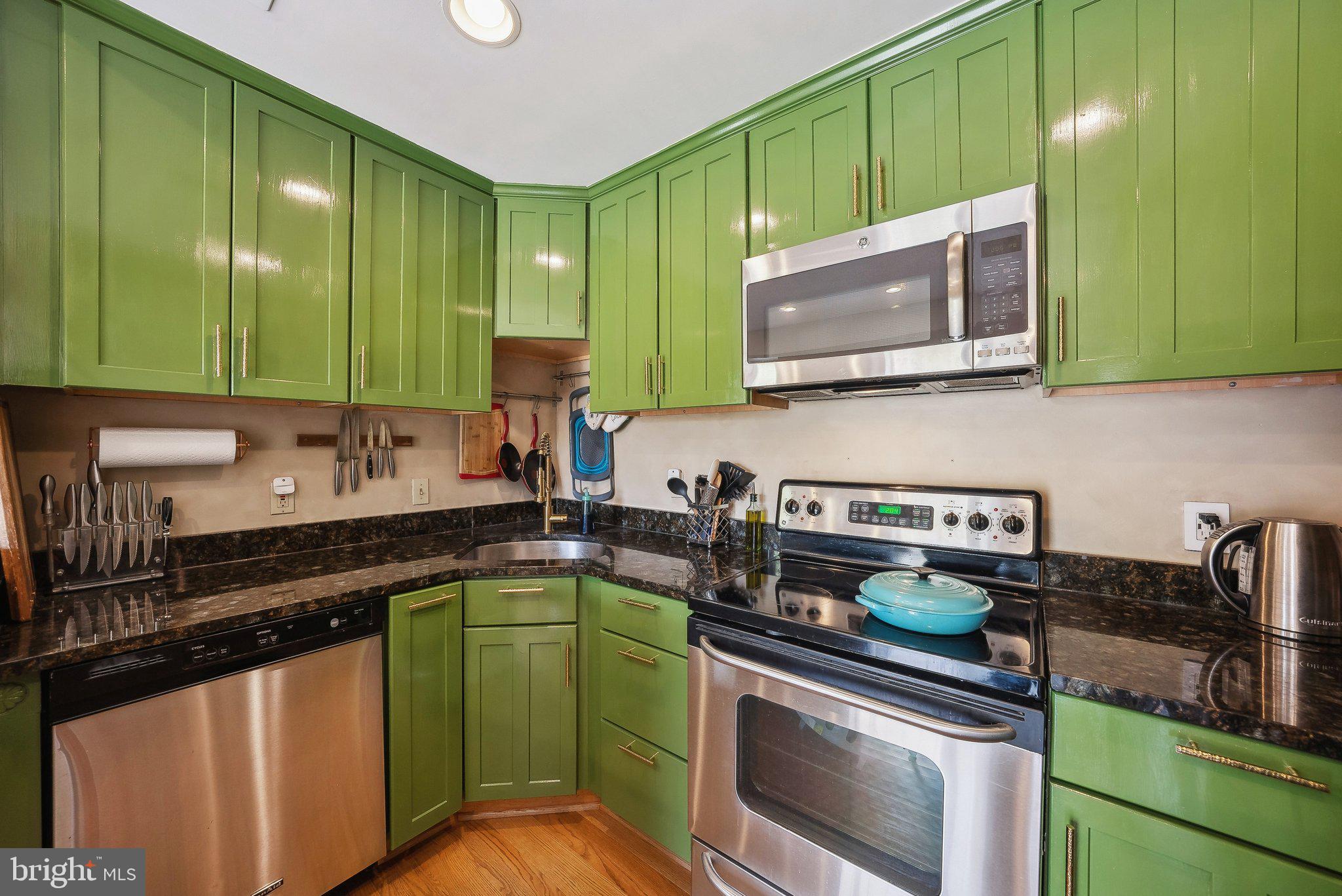 2630 Adams Mill Road Northwest, Unit 303 Washington, DC 20009 - Photo 12 of 18 a kitchen with a sink a stove and cabinets