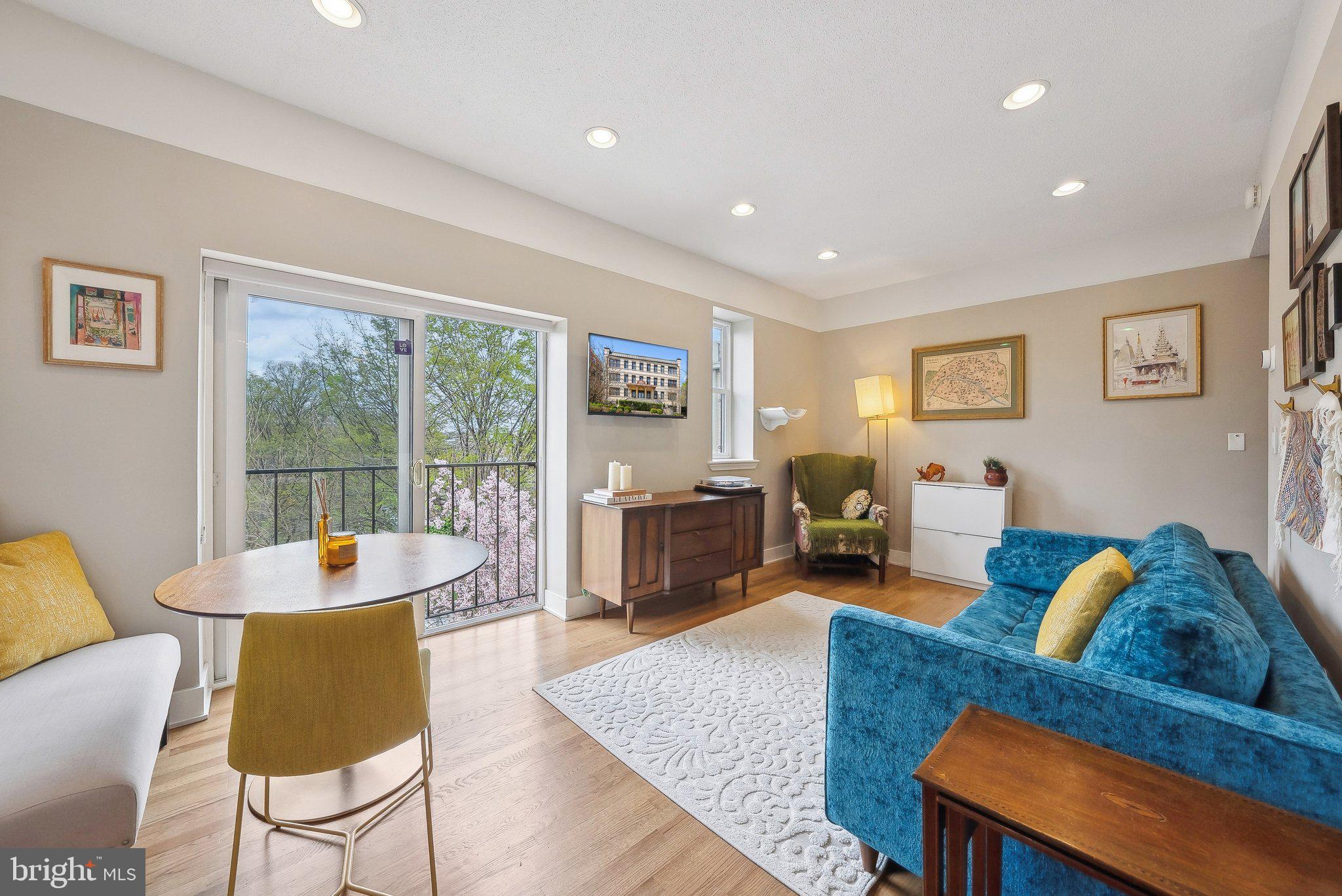 2630 Adams Mill Road Northwest, Unit 303 Washington, DC 20009 - Photo 3 of 18 a living room with furniture and a wooden floor