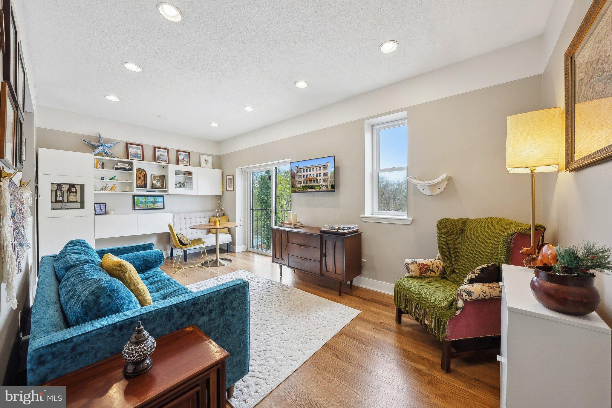 2630 Adams Mill Road Northwest, Unit 303 Washington, DC 20009 - Photo 4 of 18 a living room with furniture and a wooden floor