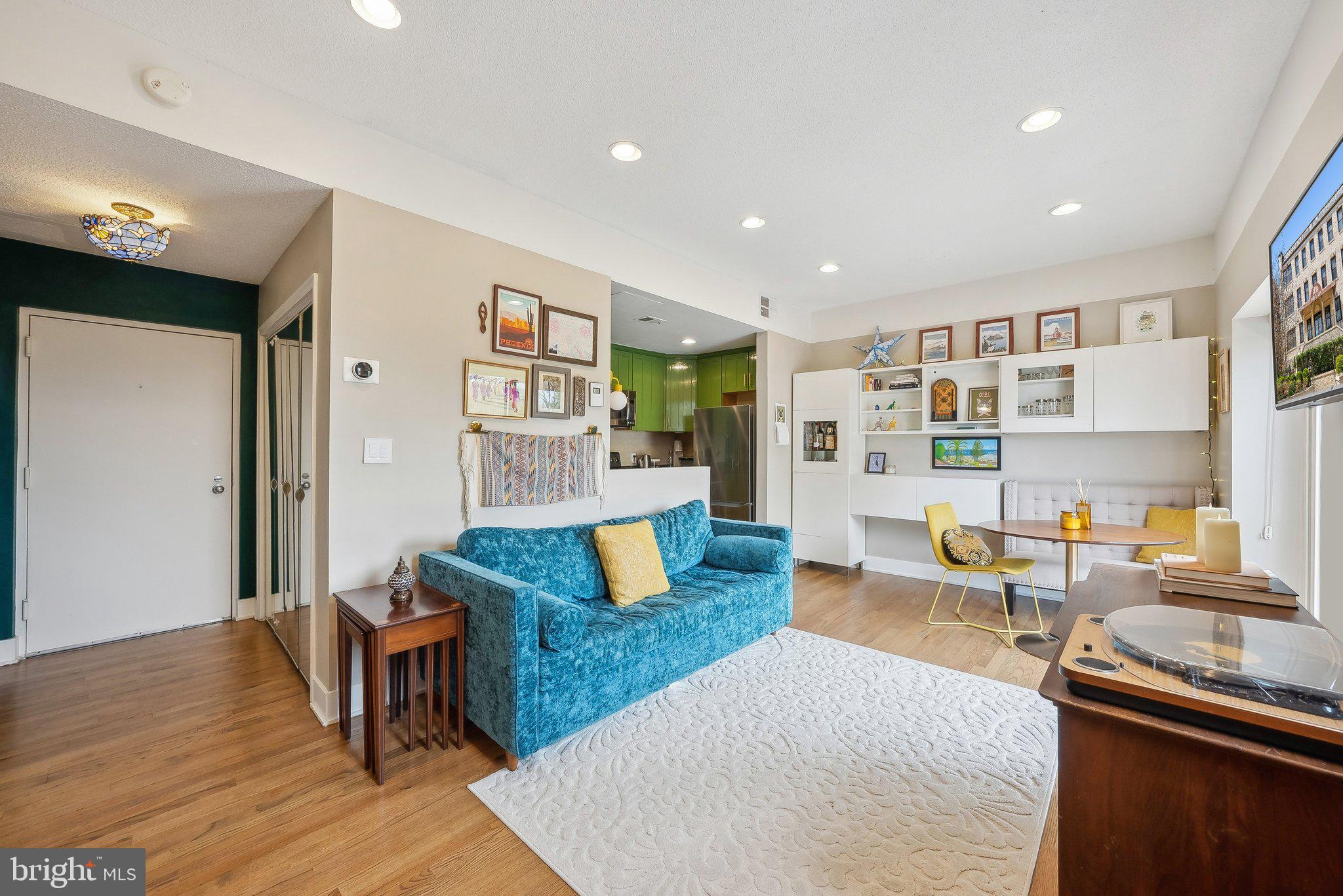 2630 Adams Mill Road Northwest, Unit 303 Washington, DC 20009 - Photo 8 of 18 a living room with furniture and a wooden floor
