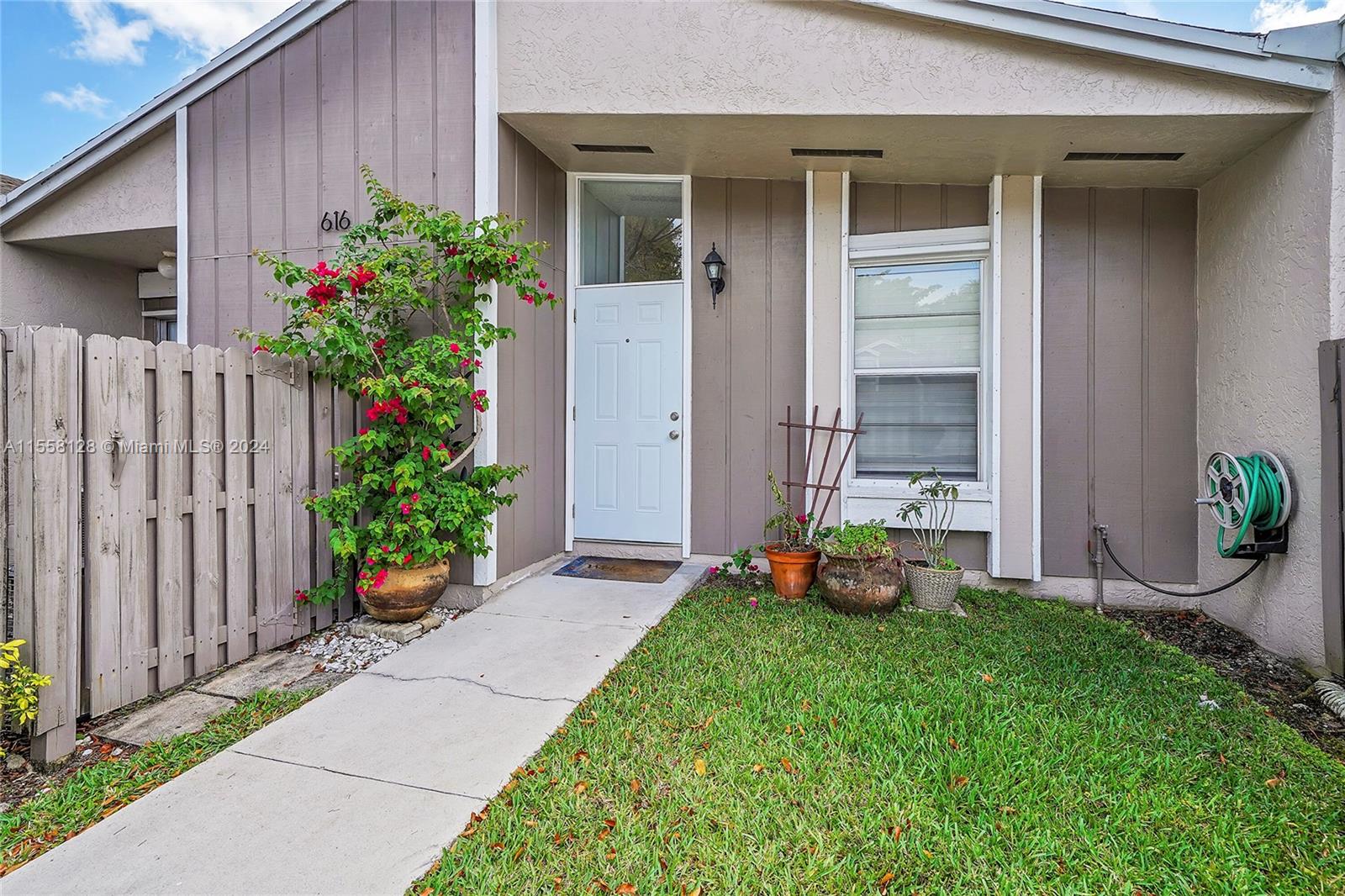 616 Woodgate Circle, Unit D Sunrise, FL 33326 - Photo 15 of 15 a garden with a table and a chair