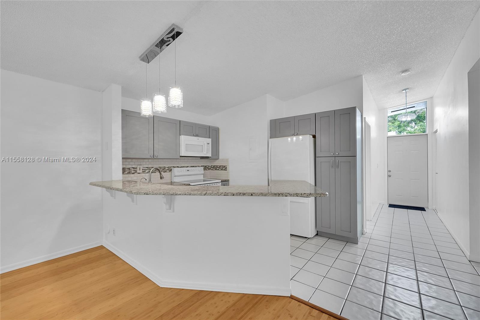 616 Woodgate Circle, Unit D Sunrise, FL 33326 - Photo 2 of 15 a kitchen with stainless steel appliances a sink and a refrigerator