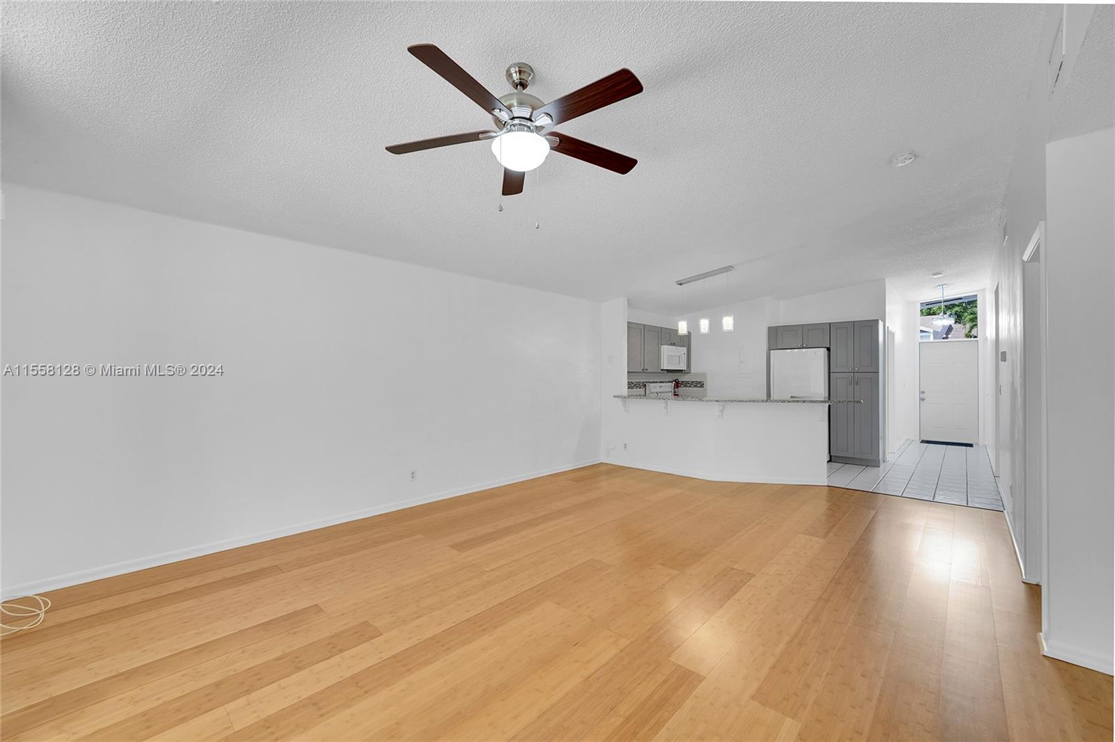616 Woodgate Circle, Unit D Sunrise, FL 33326 - Photo 3 of 15 a view of empty room with wooden floor