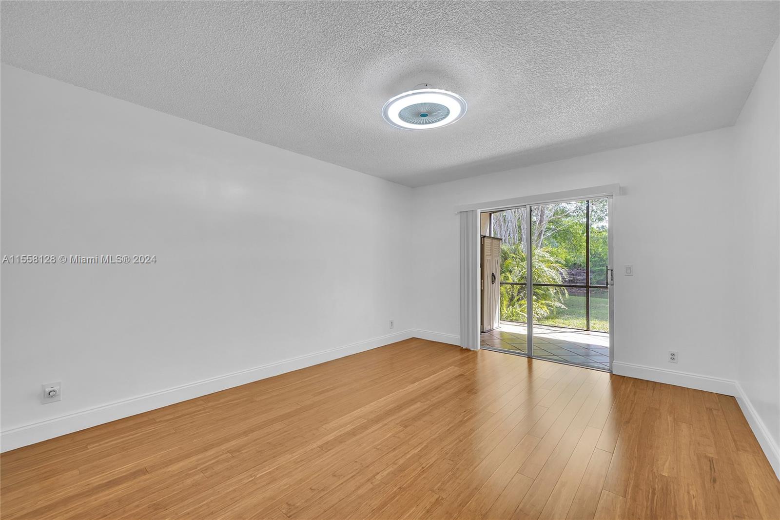 616 Woodgate Circle, Unit D Sunrise, FL 33326 - Photo 6 of 15 wooden floor in an empty room with a window