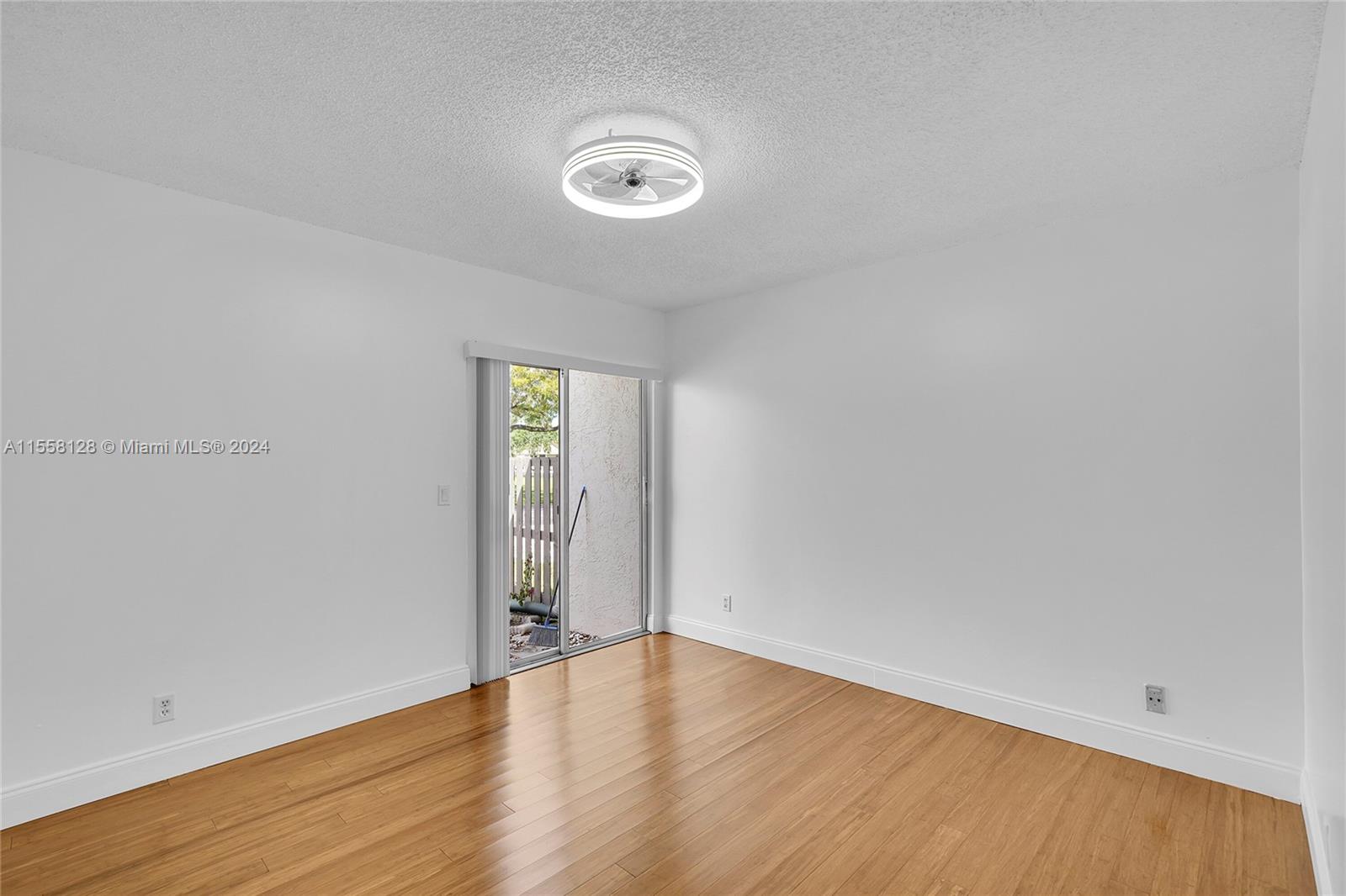 616 Woodgate Circle, Unit D Sunrise, FL 33326 - Photo 10 of 15 a view of an empty room with wooden floor and closet