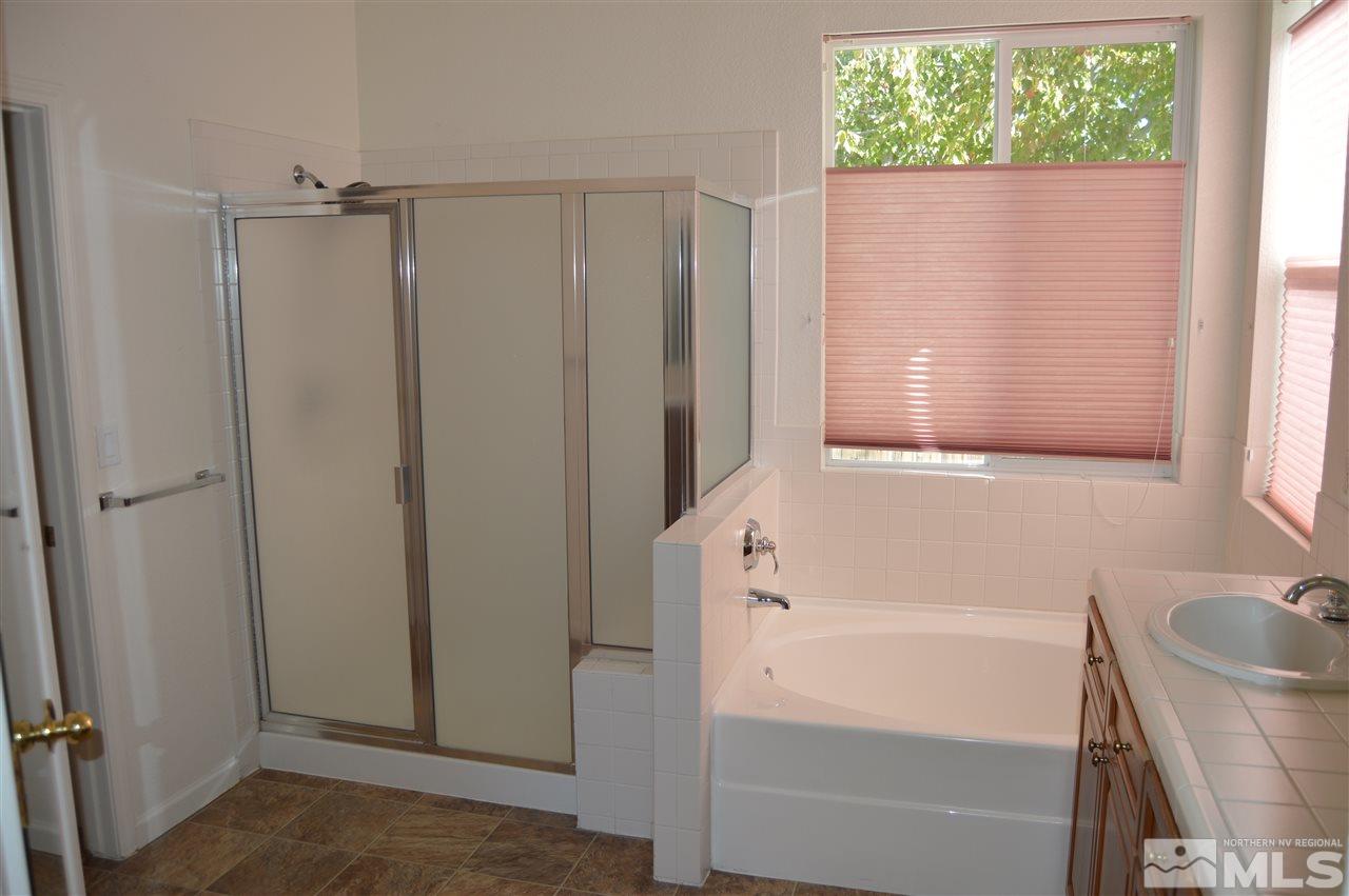 1170 Broadview Court Reno, NV 89521 - Photo 13 of 25 a bathroom with a bathtub and a shower