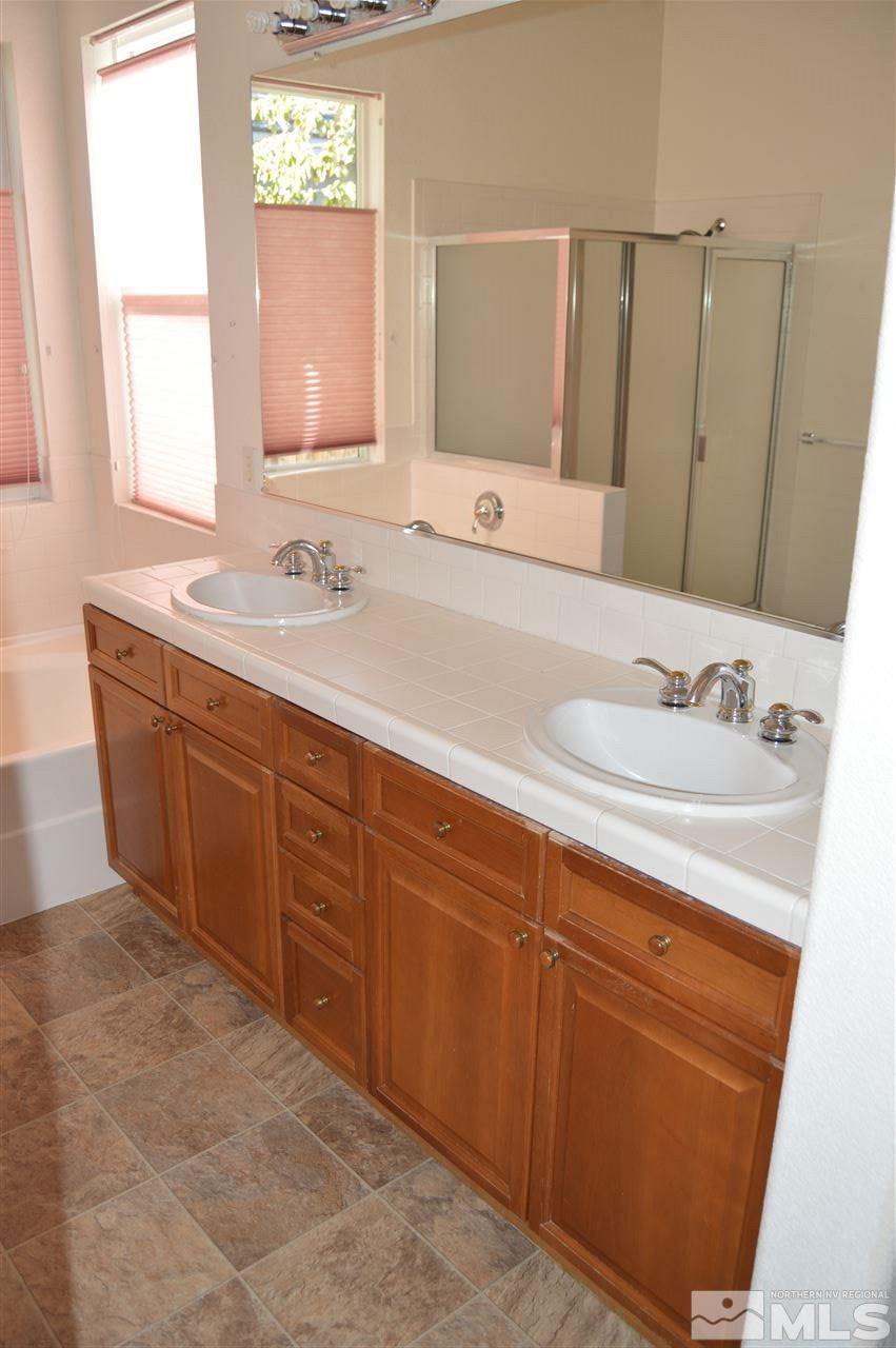 1170 Broadview Court Reno, NV 89521 - Photo 14 of 25 a bathroom with a sink and a mirror