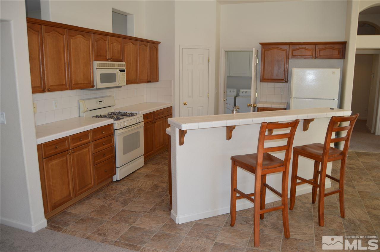 1170 Broadview Court Reno, NV 89521 - Photo 4 of 25 a kitchen with stainless steel appliances granite countertop a stove a sink and a microwave