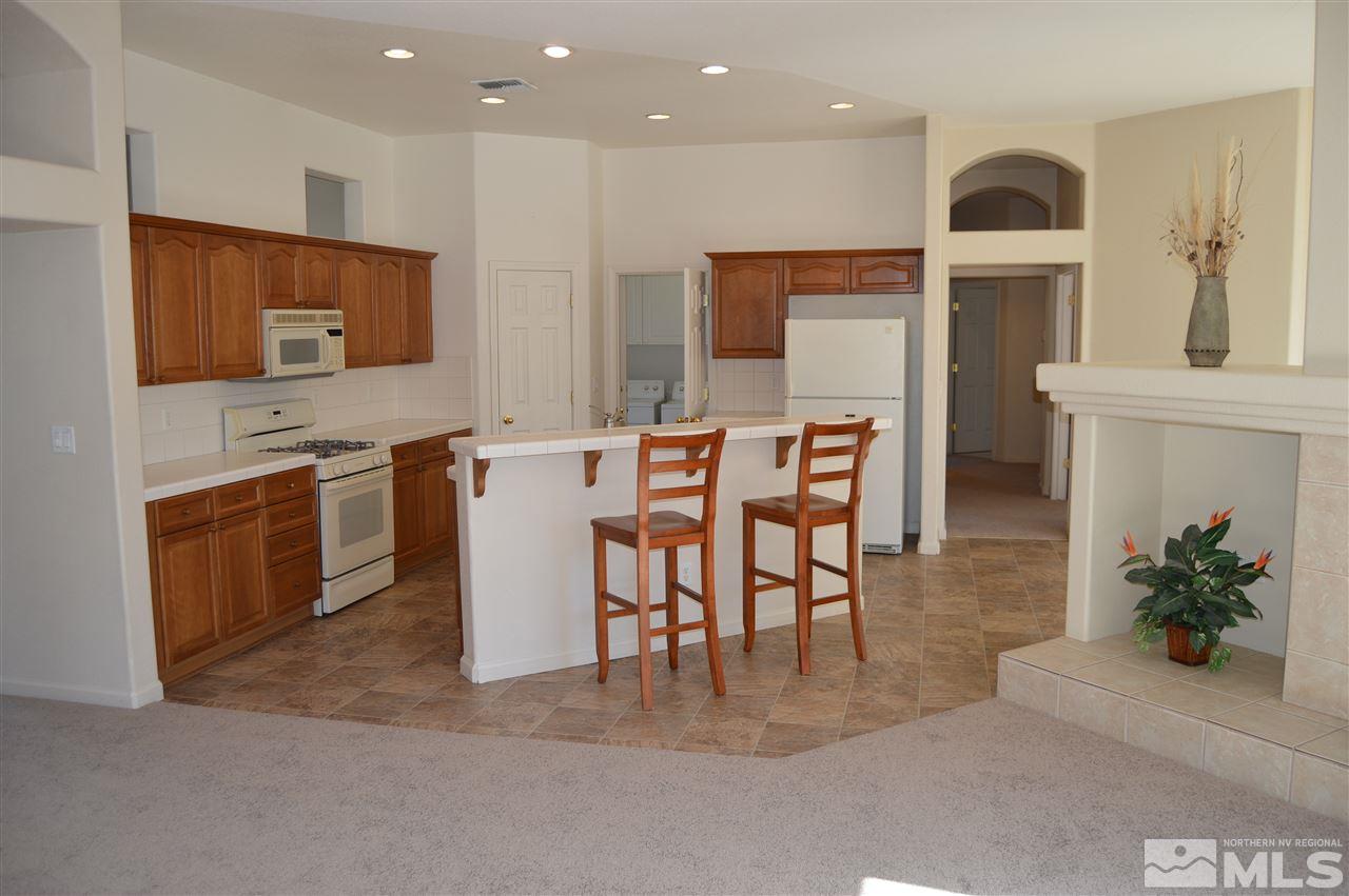 1170 Broadview Court Reno, NV 89521 - Photo 5 of 25 a view of a kitchen with kitchen island stainless steel appliances refrigerator stove microwave and cabinets
