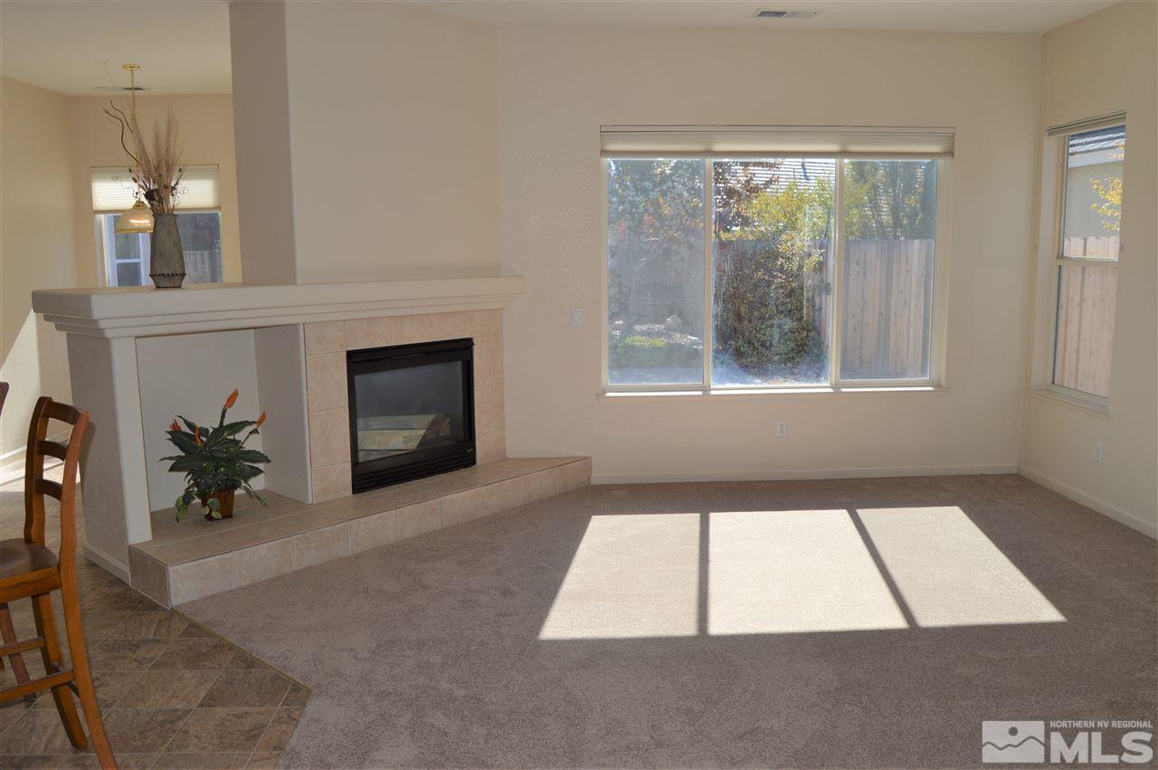 1170 Broadview Court Reno, NV 89521 - Photo 8 of 25 an empty room with windows and fireplace
