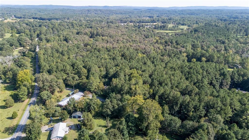 496 Flat Woods Road Calhoun, GA 30701 - Photo 19 of 21 an aerial view of a houses with a lush green hillside