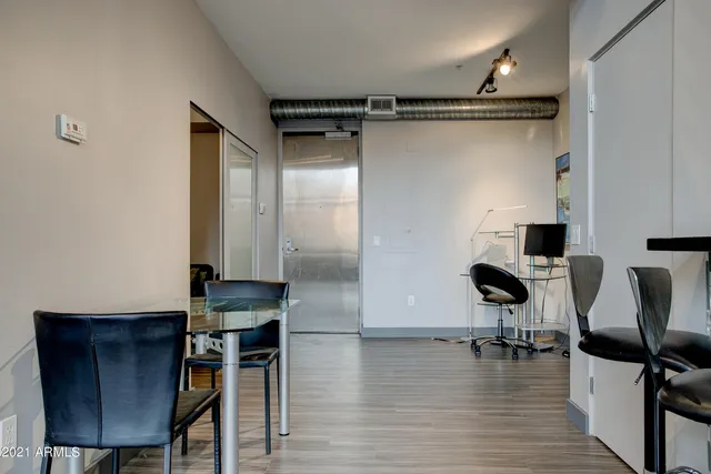 a view of a workspace with furniture and wooden floor