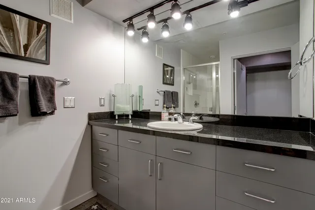 a bathroom with a double vanity sink and a mirror