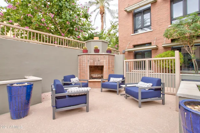 a building outdoor space with patio furniture and a fireplace