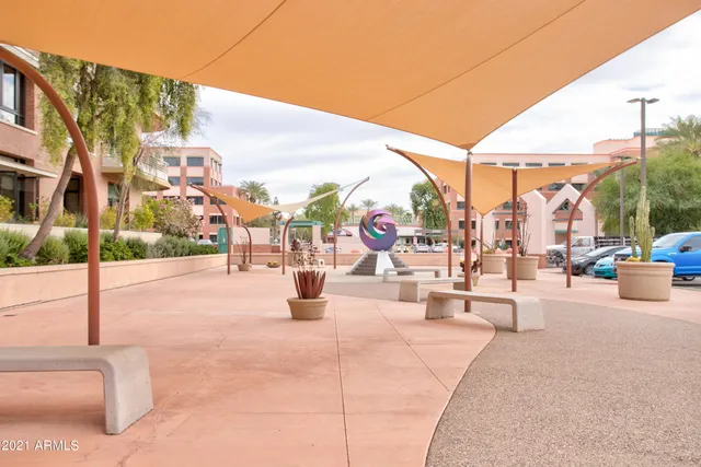 a view of roof deck with table and chairs and potted plants