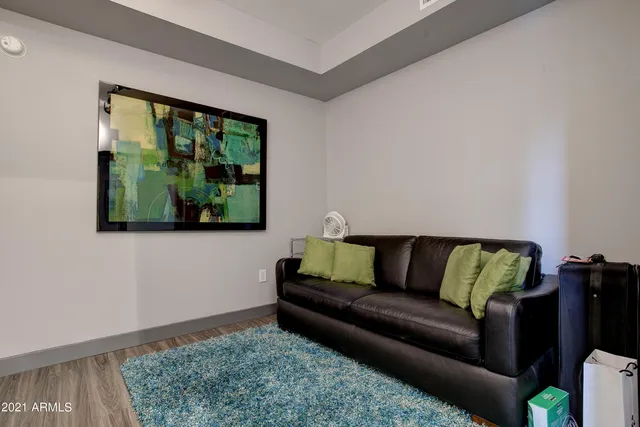 a living room with a couch and a floor to ceiling window